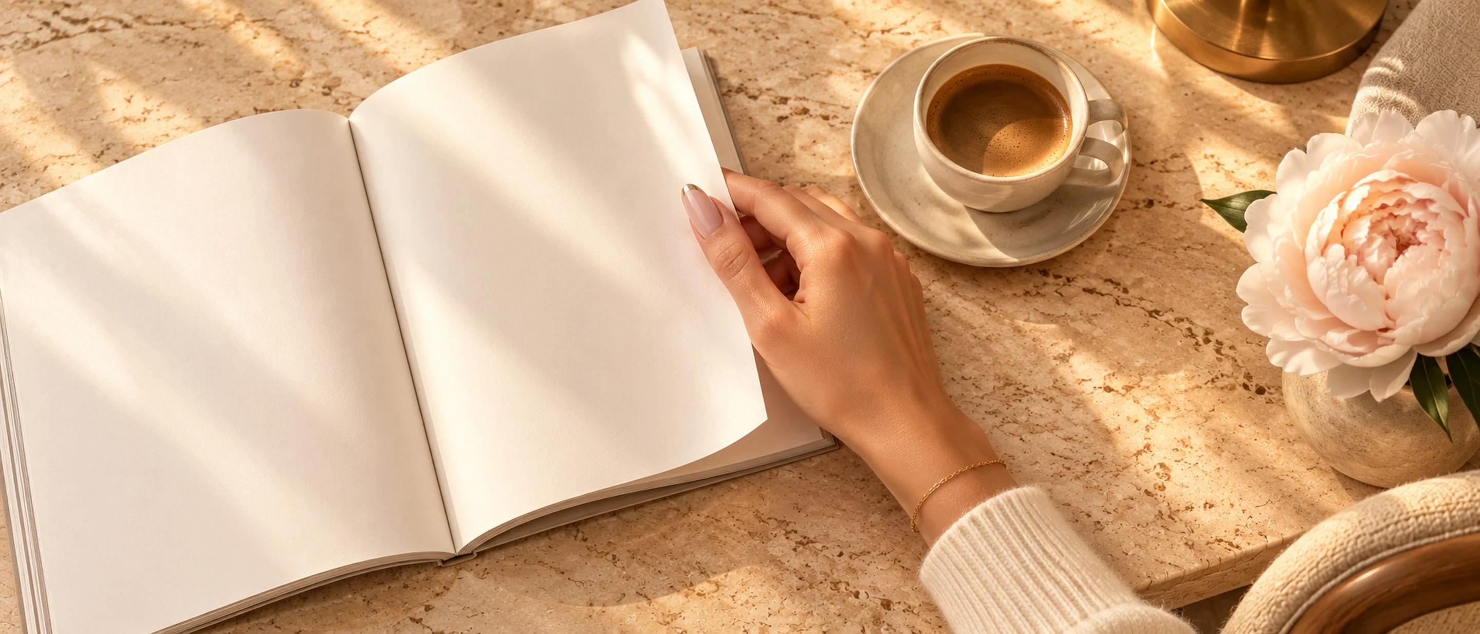 Open magazine beside a manicured hand and espresso